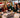 nsurance agency team enjoying a holiday moment together around a desk in a decorated office.